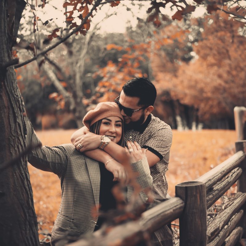 Couple portrait — rustic fence autumn foliage