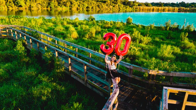 Drone portrait — 30th birthday balloons on boardwalk