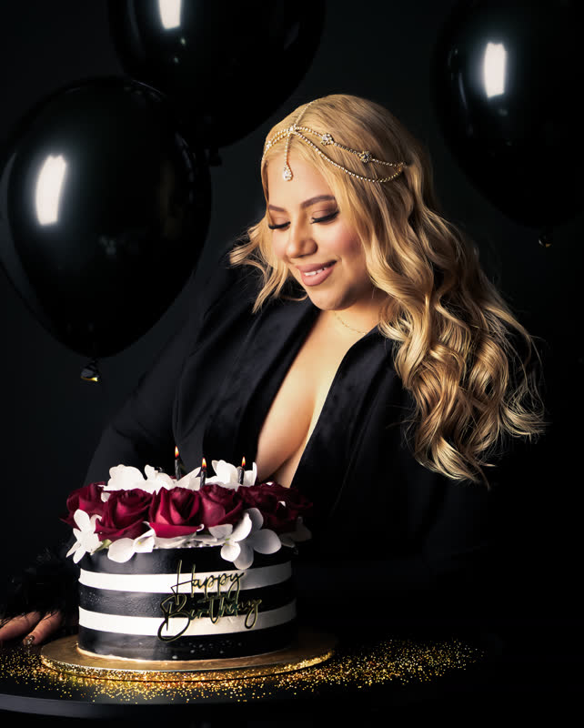 Studio birthday glam portrait with black balloons