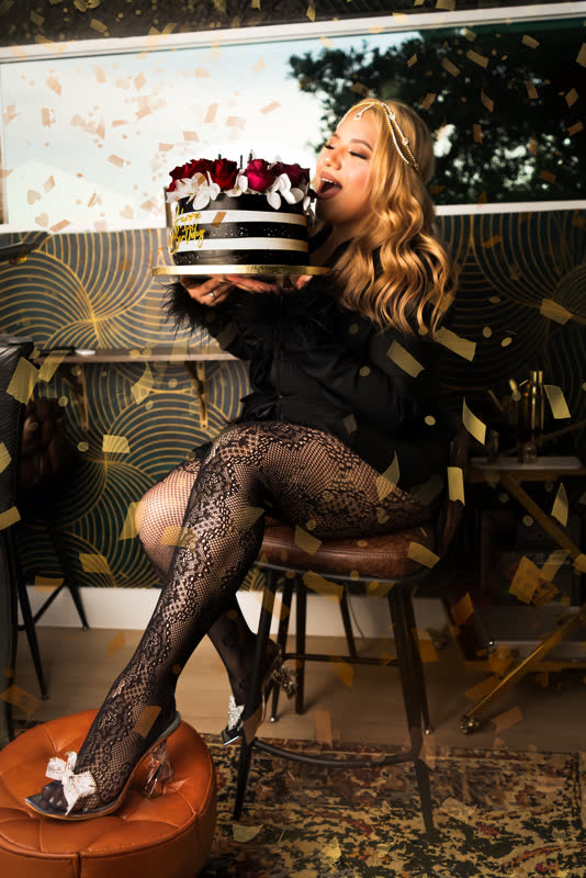 Birthday celebration portrait with cake and gold confetti